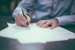 man-writing-on-paper.jpg man writing on paper