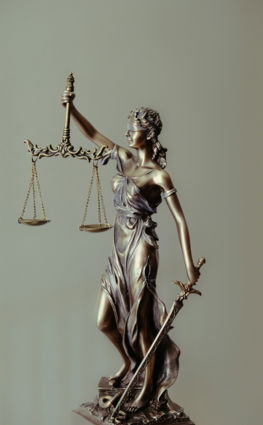woman-in-gold-dress-holding-sword-figurine.jpg woman in gold dress holding sword figurine